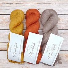 Load image into Gallery viewer, Three skeins of yarn in yellow, orange, and brown with merino and cashmere for knitting.